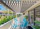 Charming patio with trellis and table, overlooking lush landscaping and providing a serene outdoor space at 6204 Midnight Pass Rd # 102, Sarasota, FL 34242