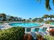 Resort-style pool area surrounded by lush landscaping and lounge chairs at 6204 Midnight Pass Rd # 102, Sarasota, FL 34242
