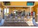 Outdoor bar area featuring a marble countertop, several barstools, and two wall-mounted televisions at 6642 Willowshire Way, Bradenton, FL 34212