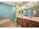 Spa-like bathroom with walk-in shower, soaking tub, double vanity, and neutral tones creating a relaxing retreat at 6642 Willowshire Way, Bradenton, FL 34212