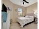 Cozy bedroom featuring tile floors, a ceiling fan, natural lighting, and stylish furniture at 6642 Willowshire Way, Bradenton, FL 34212