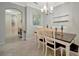 Formal dining room with an elegant chandelier, tile flooring, and neutral paint at 6642 Willowshire Way, Bradenton, FL 34212