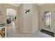 Open foyer with tile flooring, leading to the living area, featuring an arched doorway at 6642 Willowshire Way, Bradenton, FL 34212