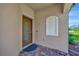Exterior front door with decorative glass, brick paver entryway, and decorative lizard at 6642 Willowshire Way, Bradenton, FL 34212