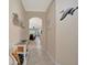 Hallway view featuring neutral paint, tile flooring and an arched doorway at 6642 Willowshire Way, Bradenton, FL 34212
