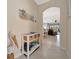 Hallway view featuring tile flooring leading to the dining and living areas, and neutral paint at 6642 Willowshire Way, Bradenton, FL 34212