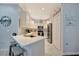 Galley style kitchen featuring white cabinets, stainless steel appliances, and quartz countertops at 6642 Willowshire Way, Bradenton, FL 34212