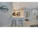 A modern kitchen with quartz countertops, a breakfast bar, and stainless steel appliances offers both style and functionality at 6642 Willowshire Way, Bradenton, FL 34212