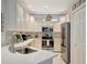 Beautiful kitchen featuring stainless steel appliances, custom cabinetry, and a decorative backsplash for culinary enthusiasts at 6642 Willowshire Way, Bradenton, FL 34212