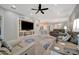 Comfortable living room with a ceiling fan, stylish rug, and a clear view of the open floor plan at 6642 Willowshire Way, Bradenton, FL 34212