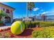 Tennis center featuring well-maintained courts, lush landscaping, and a giant decorative tennis ball at 6642 Willowshire Way, Bradenton, FL 34212