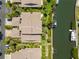 Aerial view of the residence showing the dock, landscaping, and quick access to the canal at 6780 Schooner Bay Cir # 6780, Sarasota, FL 34231