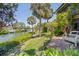 Landscaped backyard featuring views of the canal and lush greenery at 6780 Schooner Bay Cir # 6780, Sarasota, FL 34231