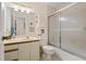 Bathroom features a vanity sink, toilet, and glass sliding shower doors at 6780 Schooner Bay Cir # 6780, Sarasota, FL 34231