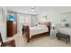 Bright bedroom showcases a wood bed frame, dresser, side table, and tiled flooring at 6780 Schooner Bay Cir # 6780, Sarasota, FL 34231