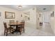 Cozy dining area with wood table, classic chairs, and tile flooring, open to the kitchen and foyer at 6780 Schooner Bay Cir # 6780, Sarasota, FL 34231