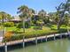 Waterfront home with lush landscaping and private dock access to canal and features palm trees at 6780 Schooner Bay Cir # 6780, Sarasota, FL 34231
