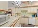 Well-lit kitchen featuring ample counter space, white cabinets, and modern appliances at 6780 Schooner Bay Cir # 6780, Sarasota, FL 34231