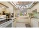 Spacious kitchen with white cabinets, ample counter space, and a view into the living room at 6780 Schooner Bay Cir # 6780, Sarasota, FL 34231