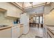 Bright kitchen with a skylight, white appliances, and tile flooring, adjacent to a cozy dining area at 6780 Schooner Bay Cir # 6780, Sarasota, FL 34231