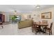 Spacious living room with a dining table, comfy seating, and access to the screened lanai at 6780 Schooner Bay Cir # 6780, Sarasota, FL 34231