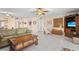 Open-concept living room featuring tile floors, comfortable seating, and entertainment center at 6780 Schooner Bay Cir # 6780, Sarasota, FL 34231