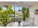Enclosed patio featuring views of the canal and tropical landscaping at 6780 Schooner Bay Cir # 6780, Sarasota, FL 34231
