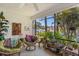 Enclosed patio offers comfortable seating and views of the canal and tropical plants at 6780 Schooner Bay Cir # 6780, Sarasota, FL 34231