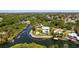 Aerial view of waterfront home with pool, dock, and lush green landscaping at 6802 68Th E Ave, Bradenton, FL 34203