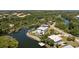 Aerial view of waterfront home with pool, landscaping and dock at 6802 68Th E Ave, Bradenton, FL 34203