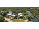 Aerial view of waterfront property showing the home and the surrounding landscape at 6802 68Th E Ave, Bradenton, FL 34203