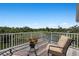 Spacious balcony with seating overlooks a verdant waterfront landscape at 6802 68Th E Ave, Bradenton, FL 34203