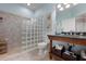 Bathroom features a tile shower enclosed with glass bricks and stylish vanity at 6802 68Th E Ave, Bradenton, FL 34203