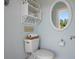 Cozy bathroom with decorated shelving, a mirror, and a view to the outdoors at 6802 68Th E Ave, Bradenton, FL 34203