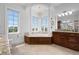 Bright bathroom features a soaking tub surrounded by large windows and wood cabinets at 6802 68Th E Ave, Bradenton, FL 34203