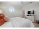 Bright bedroom features a large bed and octagon window providing natural light at 6802 68Th E Ave, Bradenton, FL 34203