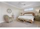 Bedroom featuring carpeted floors, a wicker bed frame, and comfortable accent chairs at 6802 68Th E Ave, Bradenton, FL 34203