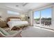 Bright bedroom features balcony access, carpeted floors, and wicker furniture at 6802 68Th E Ave, Bradenton, FL 34203
