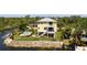 A charming waterfront home with a metal roof, multi-level balconies, a pool, and manicured landscaping at 6802 68Th E Ave, Bradenton, FL 34203