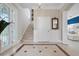 Bright foyer with staircase, tiled floor, and white trim at 6802 68Th E Ave, Bradenton, FL 34203