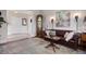 Foyer area featuring wood and tiled flooring, a grandfather clock and a tufted leather couch at 6802 68Th E Ave, Bradenton, FL 34203