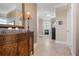 Hallway featuring tile floors, neutral paint, and decorative wood furniture at 6802 68Th E Ave, Bradenton, FL 34203