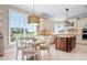 Open kitchen featuring custom cabinets, an island, and stainless appliances at 6802 68Th E Ave, Bradenton, FL 34203