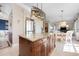 Stylish kitchen island with wooden cabinetry, granite countertops, and modern lighting at 6802 68Th E Ave, Bradenton, FL 34203