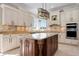 Kitchen with granite countertops, wooden island, and stainless steel appliances at 6802 68Th E Ave, Bradenton, FL 34203
