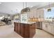 Kitchen featuring a kitchen island, stone countertops, stainless appliances, and open floor plan at 6802 68Th E Ave, Bradenton, FL 34203