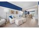 Comfortable living room featuring wainscoting, bright blue accent paint, and an archway to the dining area at 6802 68Th E Ave, Bradenton, FL 34203
