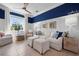 Bright living room featuring neutral furniture, blue accents, and large windows at 6802 68Th E Ave, Bradenton, FL 34203