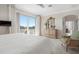 Main bedroom with sliding glass doors to a private balcony overlooking lush greenery at 6802 68Th E Ave, Bradenton, FL 34203