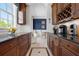 Pantry with wooden cabinets and stone countertops that leads to the dining room at 6802 68Th E Ave, Bradenton, FL 34203
